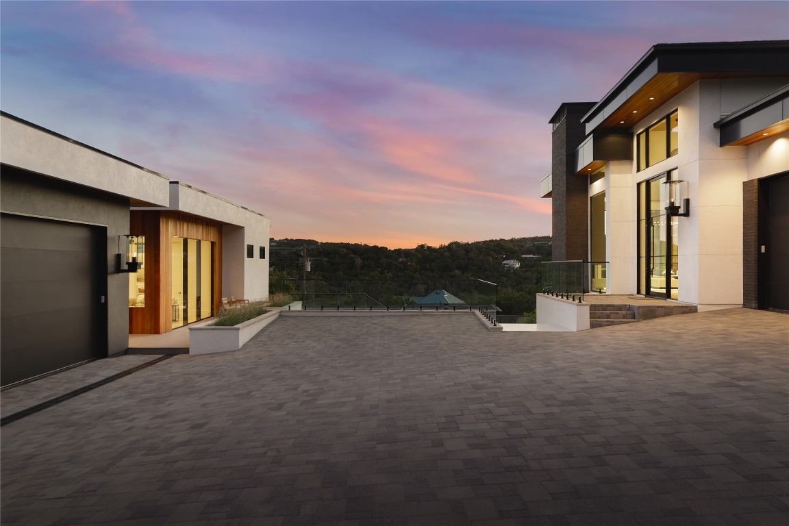 1003 The High Road Austin, TX 78746 - Photo 36 of 40 a view of a house with backyard and road