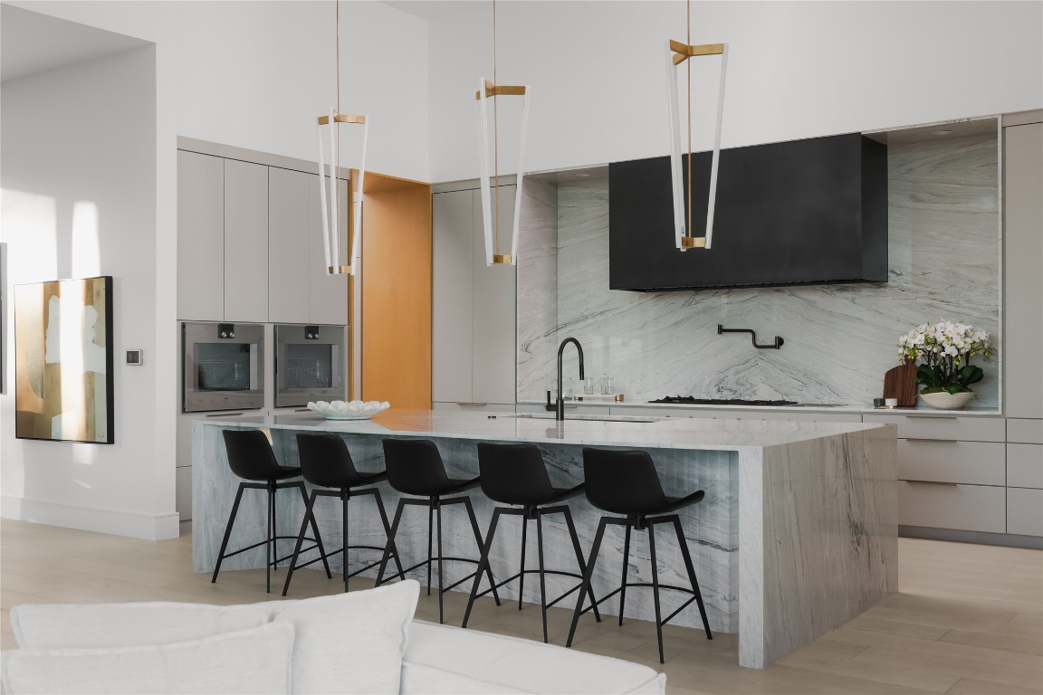 1003 The High Road Austin, TX 78746 - Photo 5 of 40 a kitchen with stainless steel appliances a sink and a refrigerator