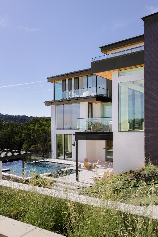 1003 The High Road Austin, TX 78746 - Photo 6 of 40 a front view of a house with garden