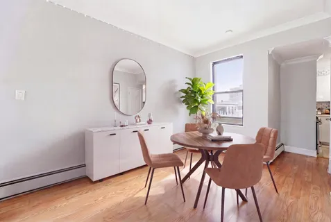 a view of a dining room with furniture and a potted plant