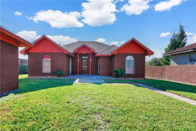 a front view of a house with yard and porch