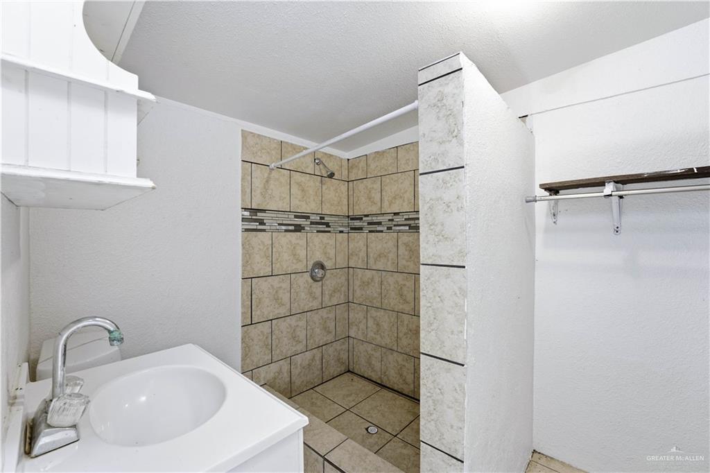 8516 Hendrix Avenue, Unit 3 Edinburg, TX 78542 - Photo 4 of 6 a bathroom with a shower and sink