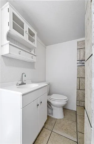 a bathroom with a sink a toilet and a mirror