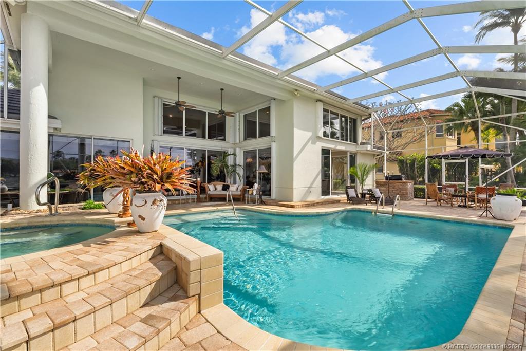 560 Southwest Bay Pointe Circle Palm City, FL 34990 - Photo 54 of 66 a view of a house with backyard porch and sitting area