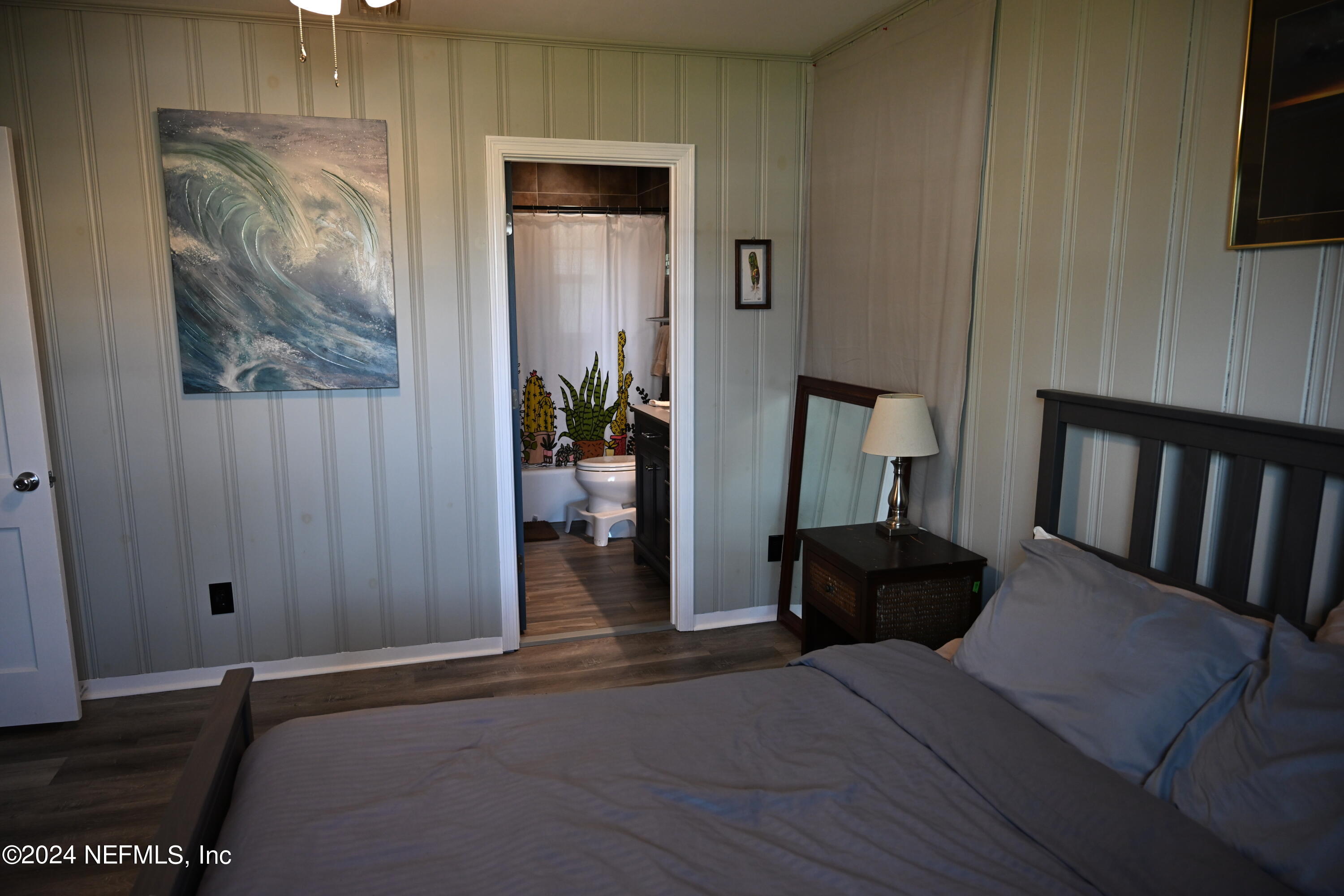 5054 Pirates Cove Road Jacksonville, FL 32210 - Photo 14 of 27 a view of a hallway with wooden floor and furniture
