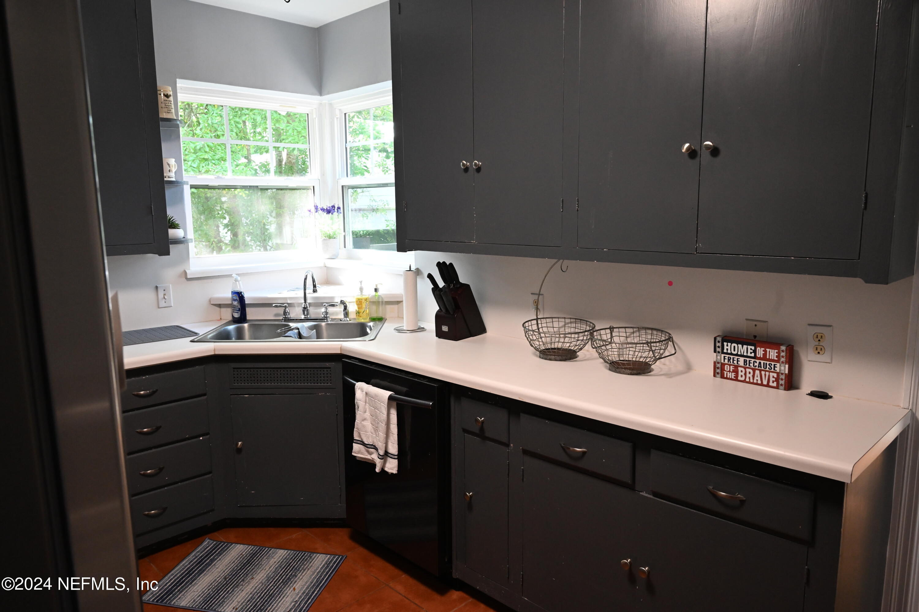 5054 Pirates Cove Road Jacksonville, FL 32210 - Photo 17 of 27 a kitchen with a sink cabinets and window