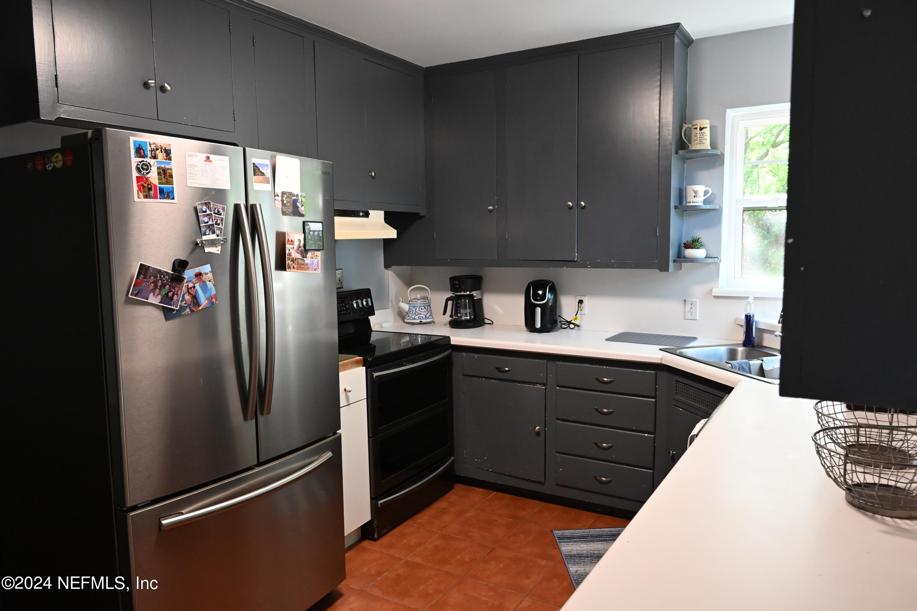 5054 Pirates Cove Road Jacksonville, FL 32210 - Photo 18 of 27 a kitchen with stainless steel appliances granite countertop a refrigerator and a sink