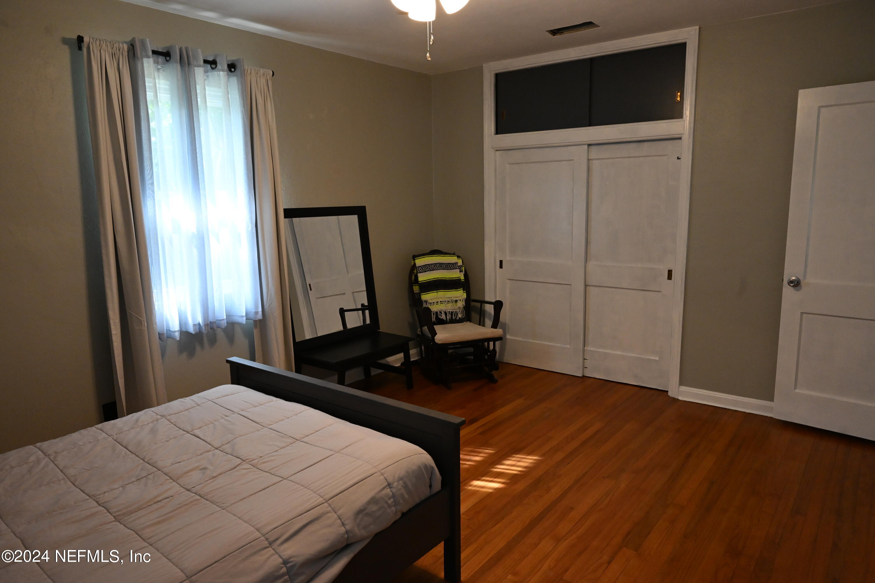 5054 Pirates Cove Road Jacksonville, FL 32210 - Photo 26 of 27 a bedroom with a bed and a mirror