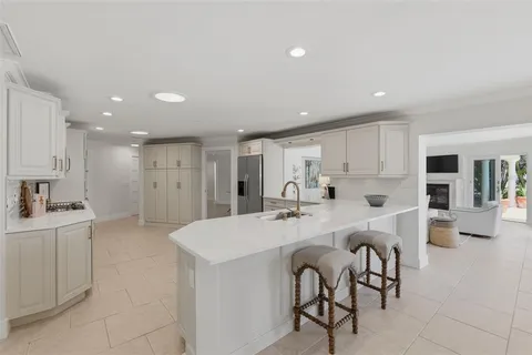 a kitchen with white cabinets and appliances