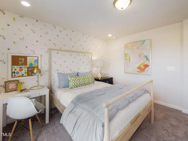 a bedroom with a bed and a table in it