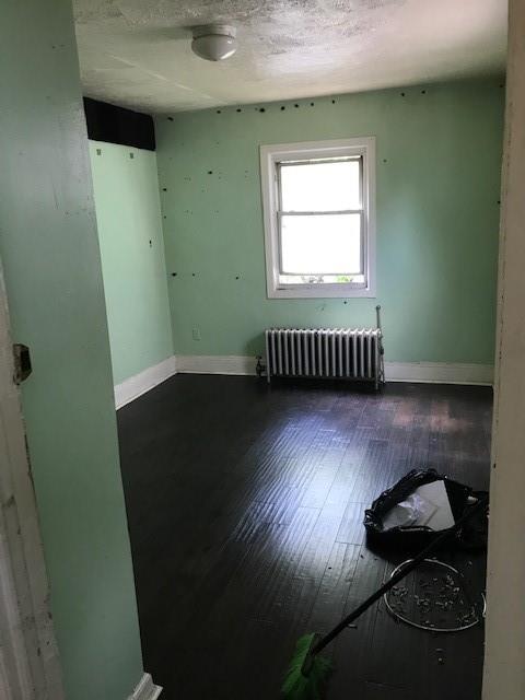 12 Pleasant Place Brooklyn, NY 11233 - Photo 2 of 12 an empty room with wooden floor and windows