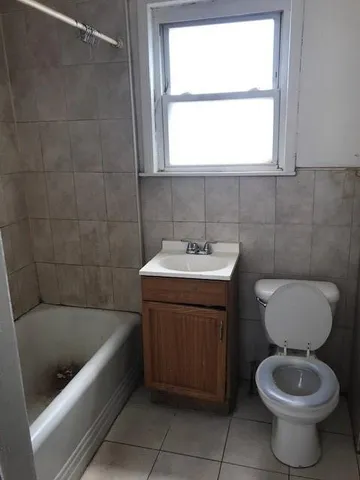 a bathroom with a sink a toilet and bathtub