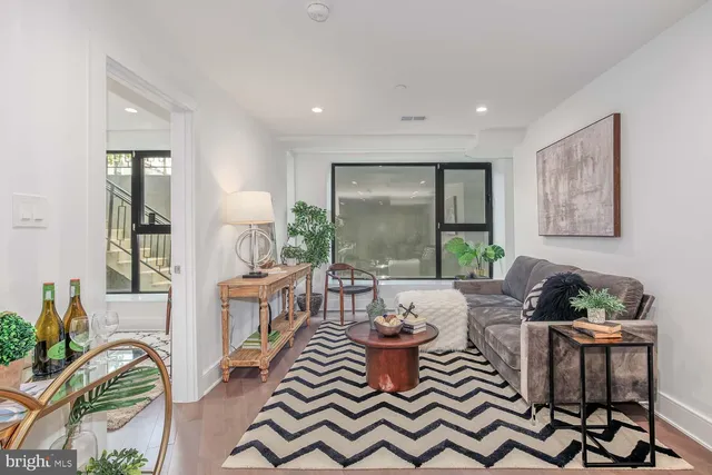 a dining room with furniture a rug and a painting