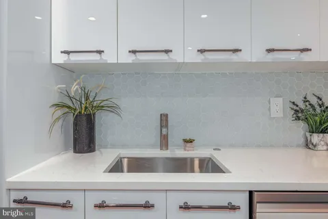 a kitchen with a sink and cabinets