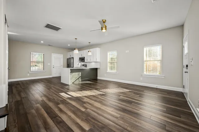 a kitchen with granite countertop a stove a sink and a microwave
