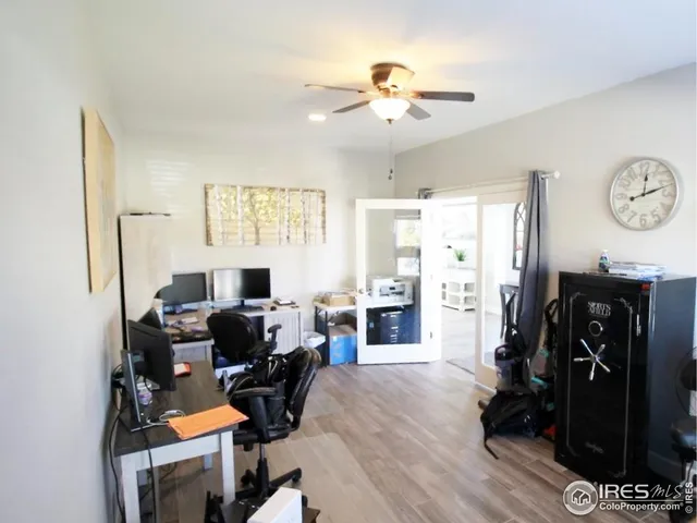 a view of a workspace with furniture and a window