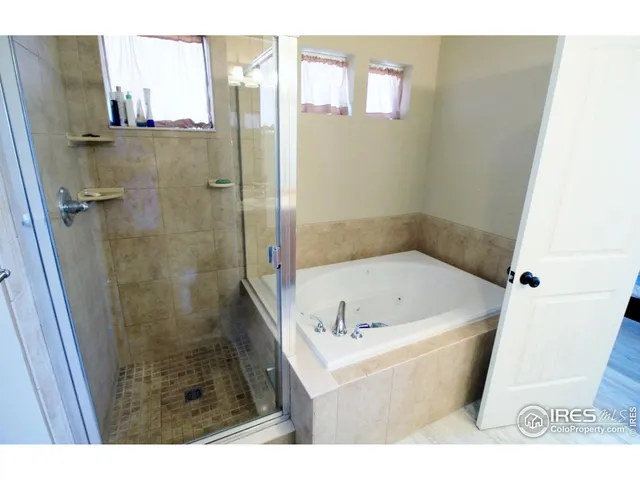 a bathroom with a bathtub and shower