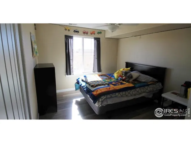 a bedroom with a bed next to a window