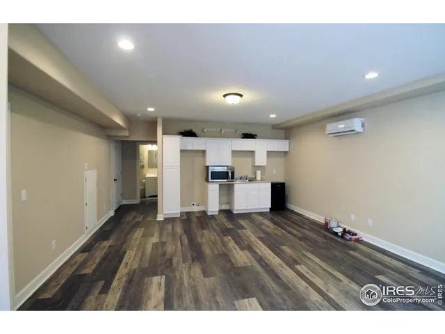 a view of a kitchen with a sink and dishwasher a refrigerator with wooden floor