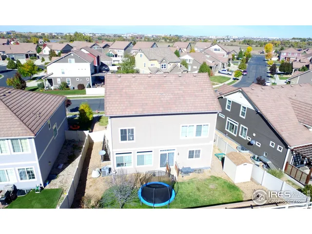 an aerial view of multiple houses with a yard