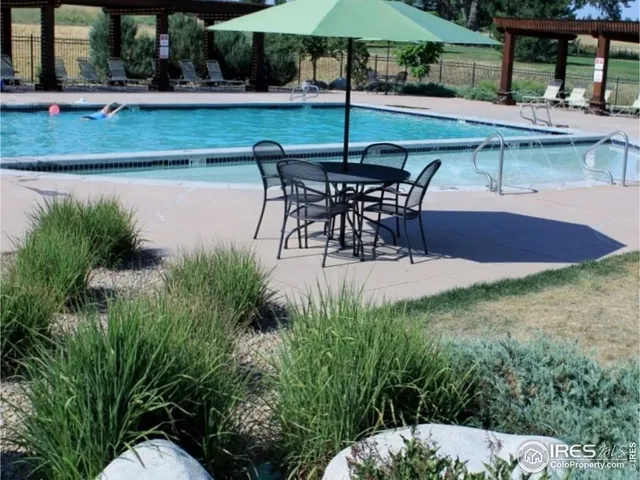 swimming pool view with a seating space