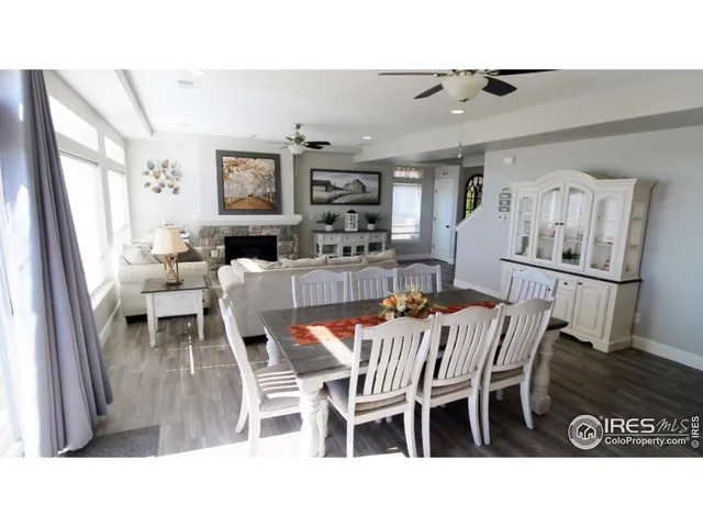 a dining room with furniture and wooden floor