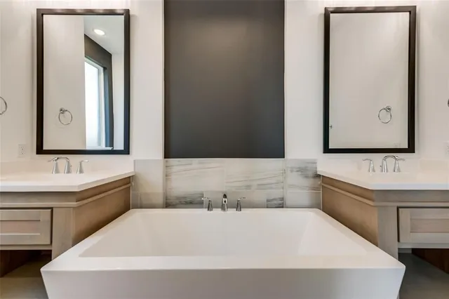 a bathroom with a bathtub and a sink