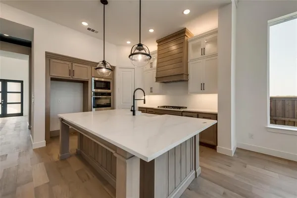 a kitchen with a stove a refrigerator and a sink