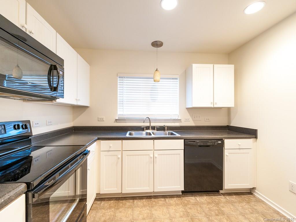 708 Elders Story Road, Unit NONE Fort Mill, SC 29708 - Photo 5 of 24 a kitchen with stainless steel appliances granite countertop a sink stove and cabinets