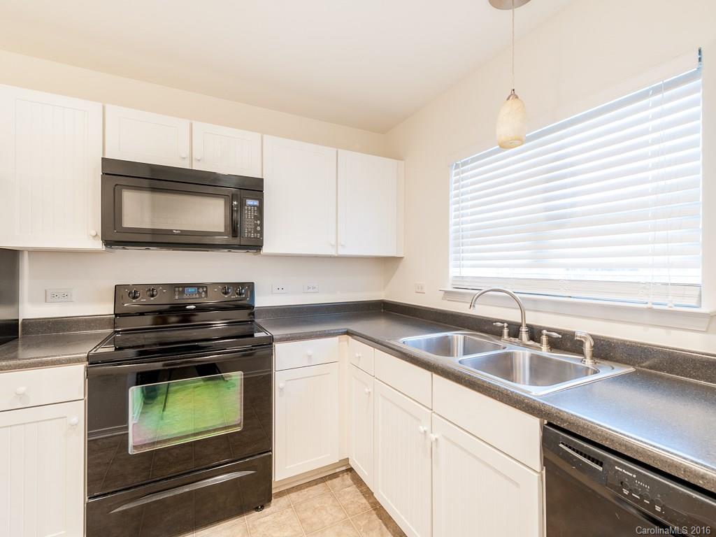 708 Elders Story Road, Unit NONE Fort Mill, SC 29708 - Photo 8 of 24 a kitchen with sink a stove and microwave