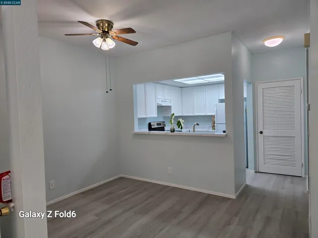 a view of a kitchen with an empty space and a ceiling fan