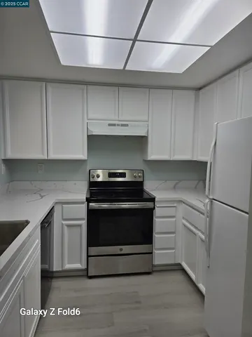a kitchen with stainless steel appliances granite countertop a stove and a refrigerator