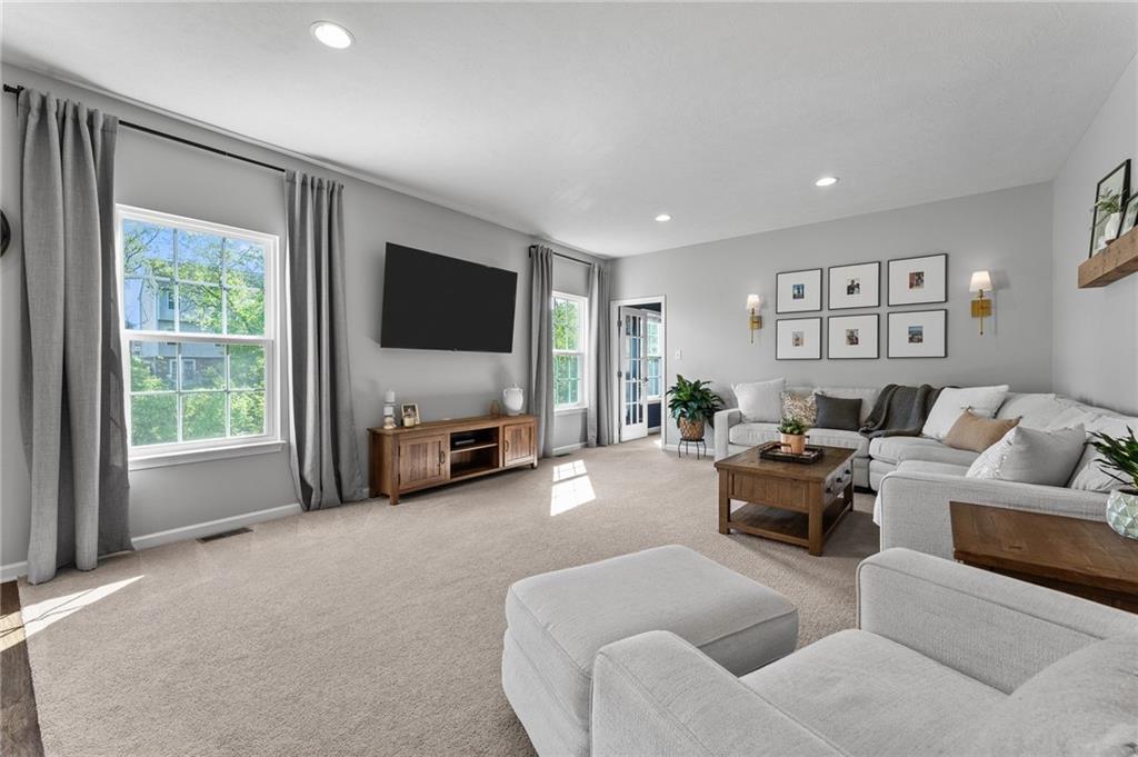 110 Brook Side Drive Clinton, PA 15026 - Photo 11 of 49 a living room with furniture a large window and a flat screen tv