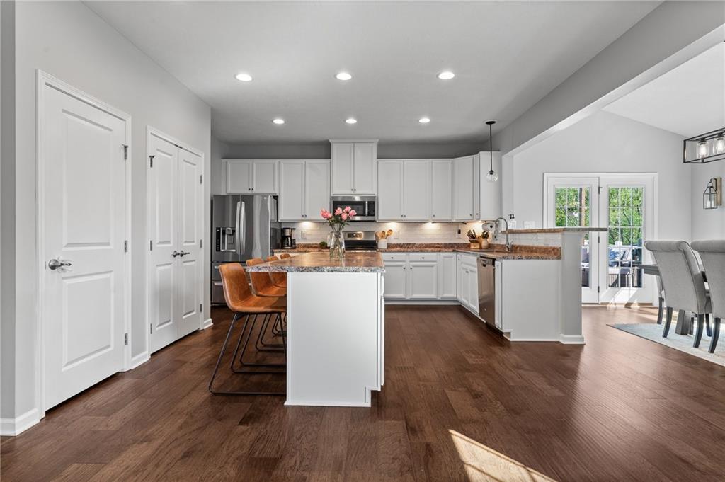 110 Brook Side Drive Clinton, PA 15026 - Photo 16 of 49 a kitchen with kitchen island granite countertop wooden floors and white stainless steel appliances