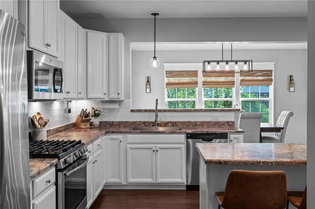 110 Brook Side Drive Clinton, PA 15026 - Photo 19 of 49 a kitchen with granite countertop a stove a sink and a refrigerator