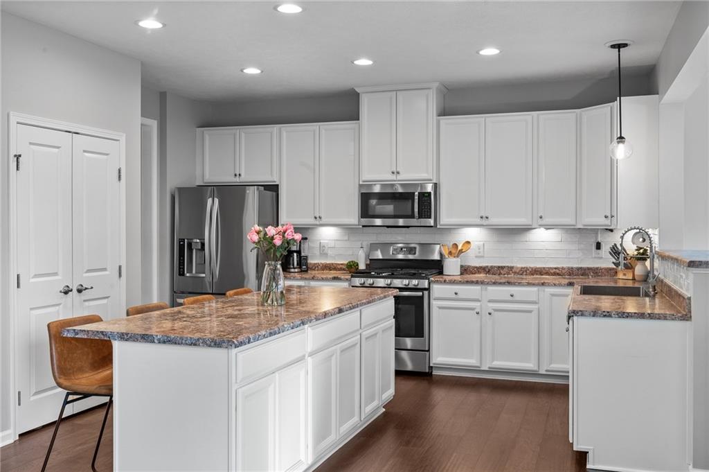 110 Brook Side Drive Clinton, PA 15026 - Photo 20 of 49 a kitchen with kitchen island granite countertop stainless steel appliances a stove refrigerator sink and microwave