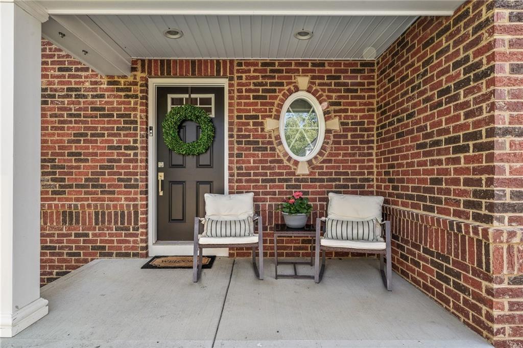 110 Brook Side Drive Clinton, PA 15026 - Photo 2 of 49 a brick building with a bench and a potted plant