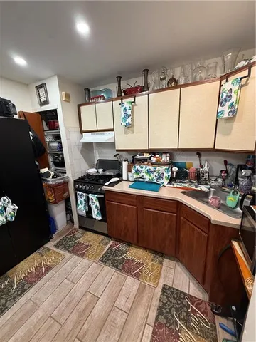 a kitchen with stainless steel appliances kitchen island granite countertop a sink stove and refrigerator