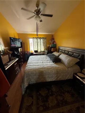 a bedroom with a bed dresser and a window