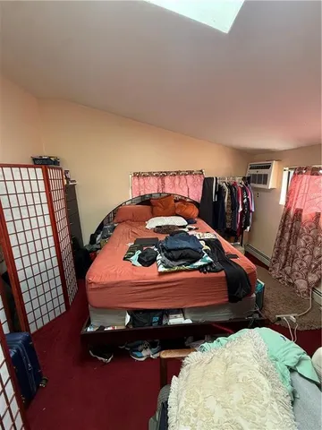 a bedroom with bed and window