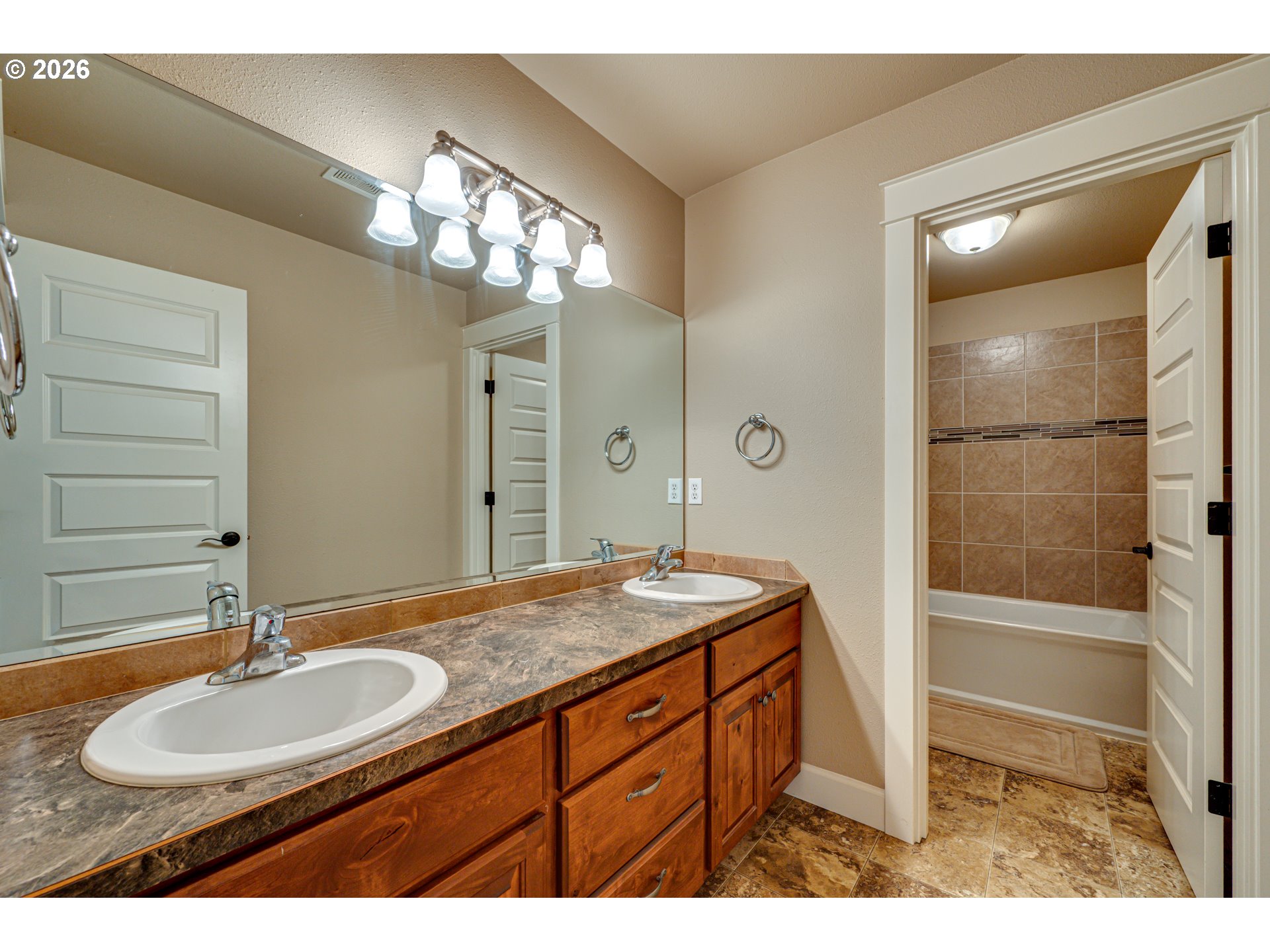 200 Pine Ridge Drive Woodland, WA 98674 - Photo 28 of 48 a bathroom with a granite countertop sink a mirror and a shower