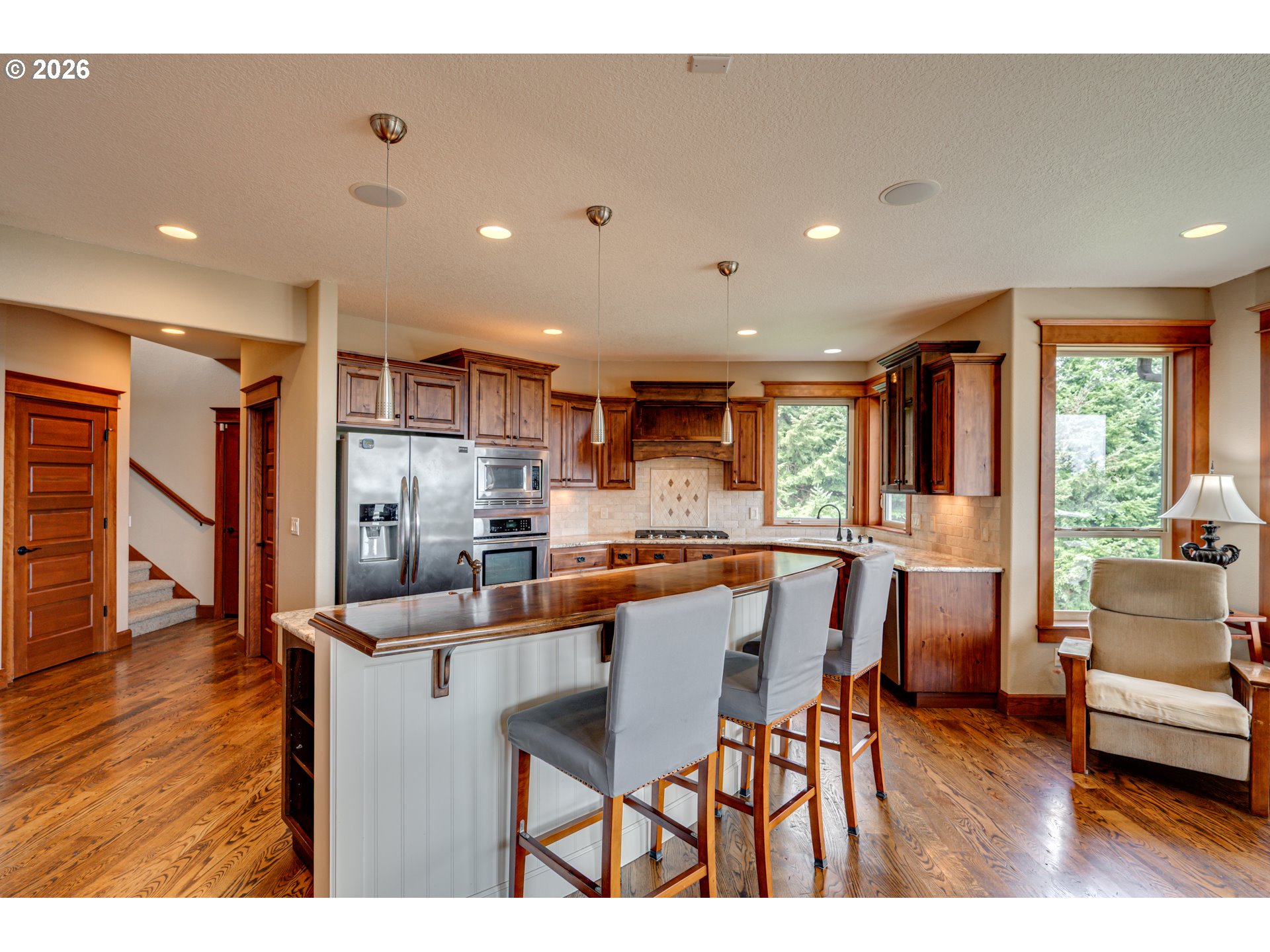 200 Pine Ridge Drive Woodland, WA 98674 - Photo 4 of 48 a dining room with stainless steel appliances furniture large window and wooden floor