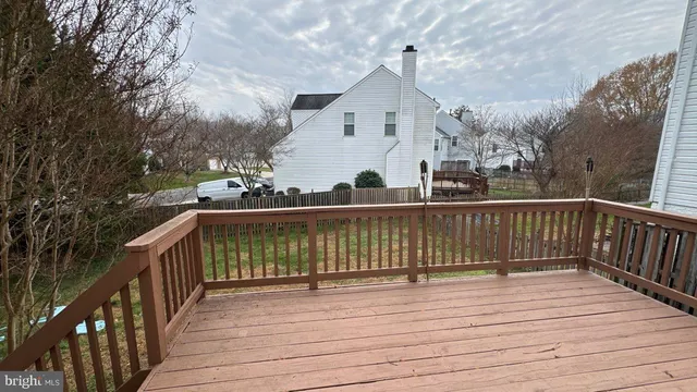 a view of balcony with wooden floor and fence