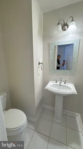 a bathroom with a sink a toilet and mirror