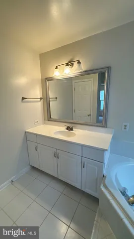 a bathroom with a double vanity sink and mirror