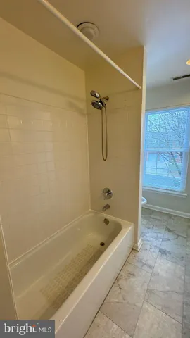 a bath tub sitting next to a shower