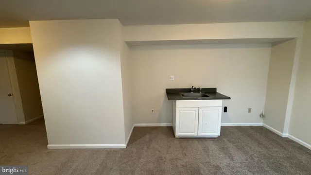a utility room with cabinets washer and dryer