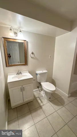 a bathroom with a sink toilet and mirror