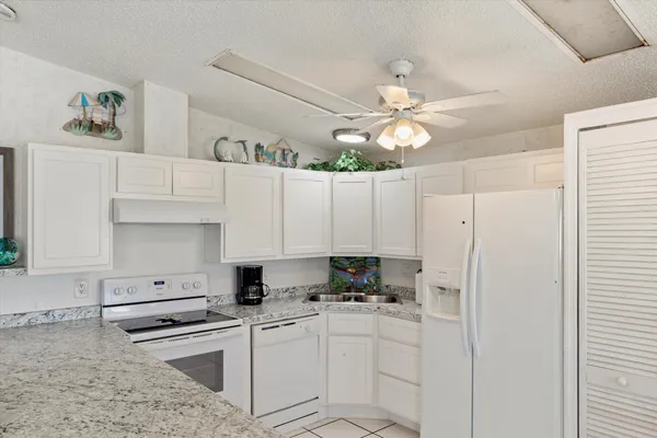 a kitchen with stainless steel appliances white cabinets and a refrigerator