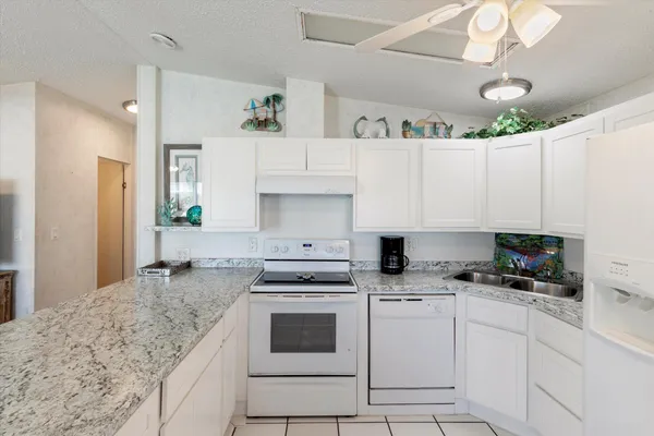 a kitchen with cabinets appliances a sink and a counter top space